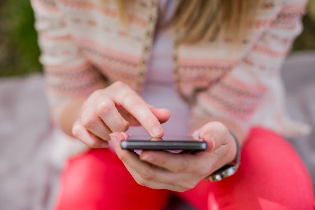 Person-sat-down-using-phone-to-show-Instagram-stories-use