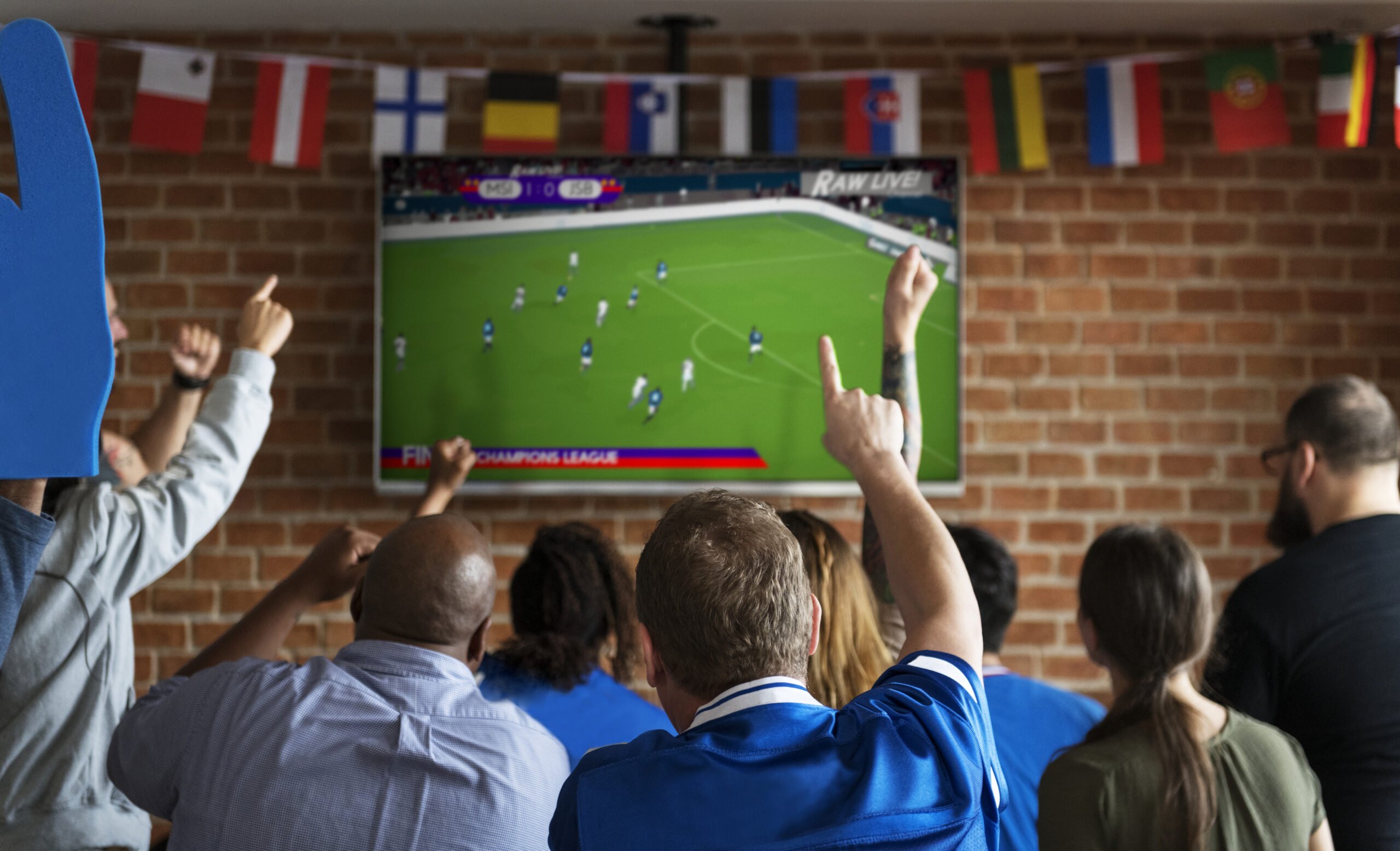 Friends-cheering-at-sport-game-on-tv-at-bar