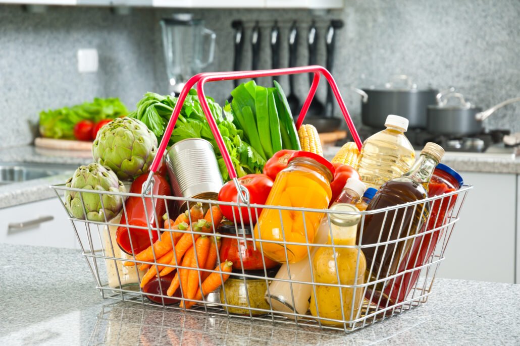 food-and-drink-pr-shot-of-full-shopping-basket-with-groceries-on-kitchen-counter-top