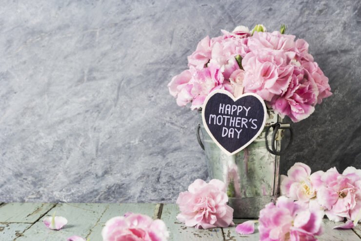 Pink-carnation-flowers-in-zinc-bucket-with-happy-mothers-day-letter-on-wood-heart