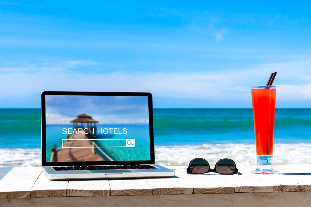consumer-pr-photo-of-hotels-search-website-on-computer-screen-with-a-beach-in-the-background