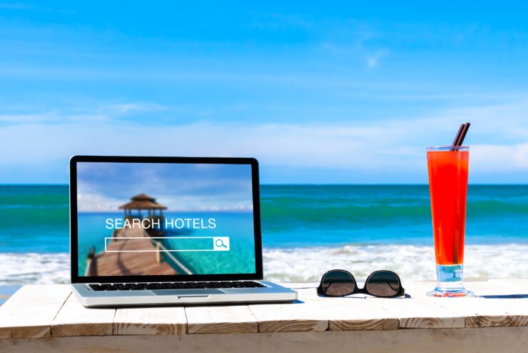 consumer-pr-photo-of-hotels-search-website-on-computer-screen-with-a-beach-in-the-background