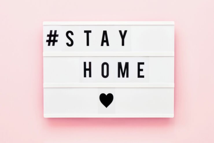 stay-home-written-on-light-box-on-pink-background