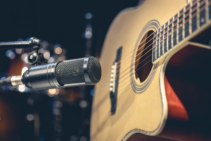 Acoustic-guitar-with-a-microphone-pointed-towards-it