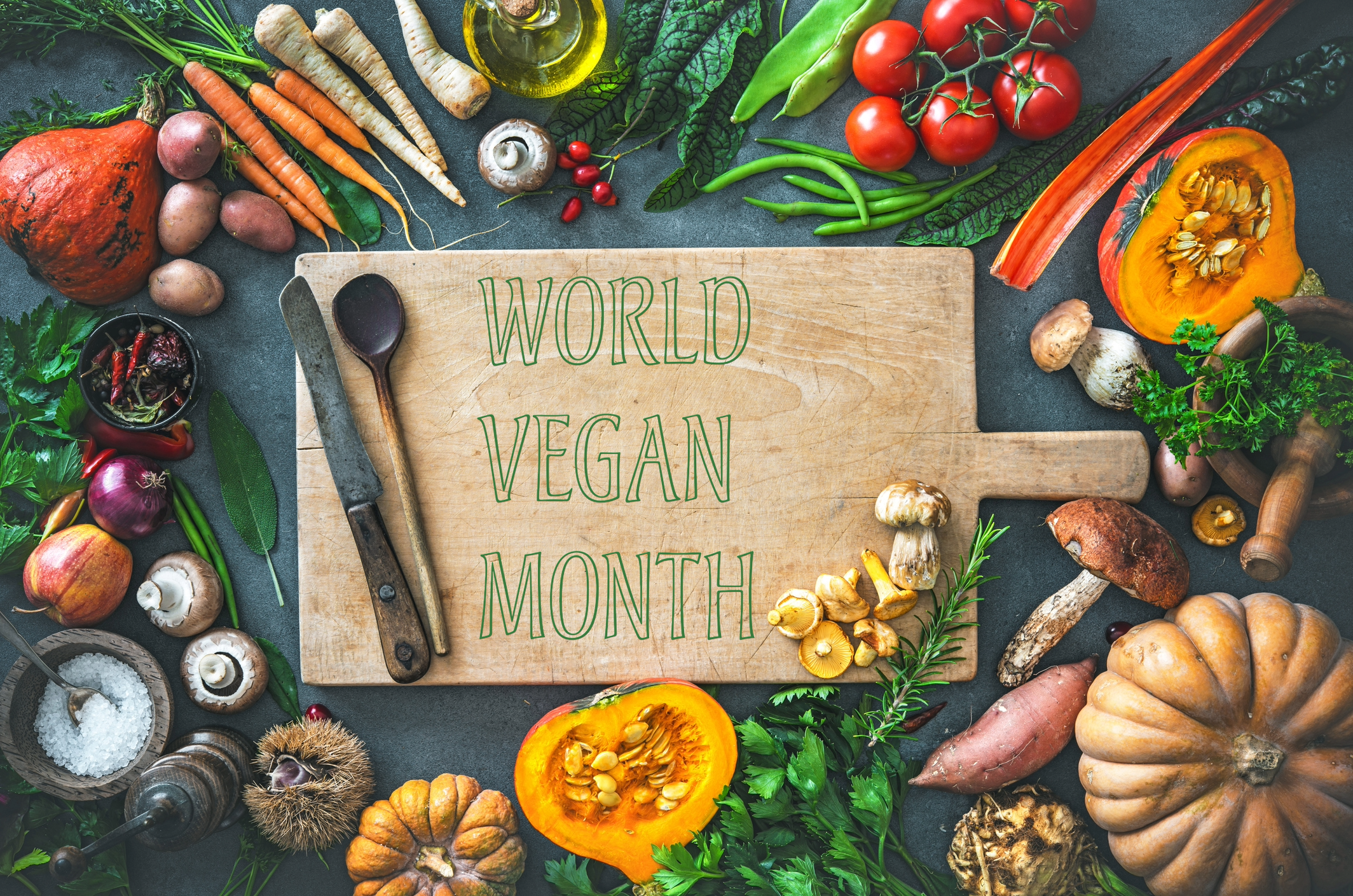 Chopping-board-with-World-Vegan-Month-written-and-vegetables-all-around