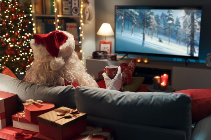 Santa-on-the-sofa-watching-Christmas-adverts-2023-on-the-TV.