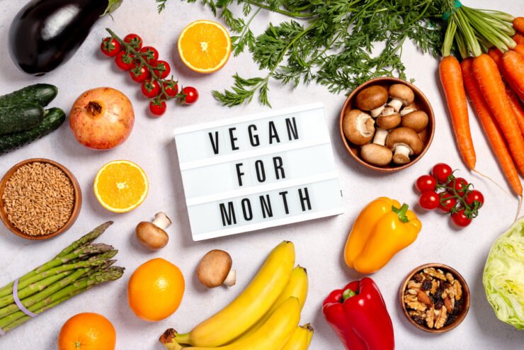 Consumer-PR-shot-of-fruits-and-vegetables-with-sign-saying-vegan-for-month