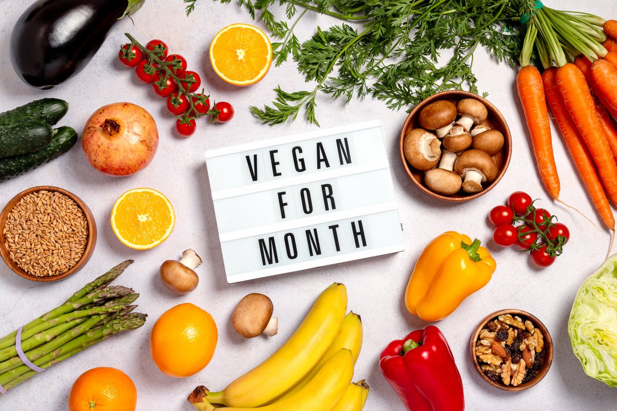 Consumer-PR-shot-of-fruits-and-vegetables-with-sign-saying-vegan-for-month