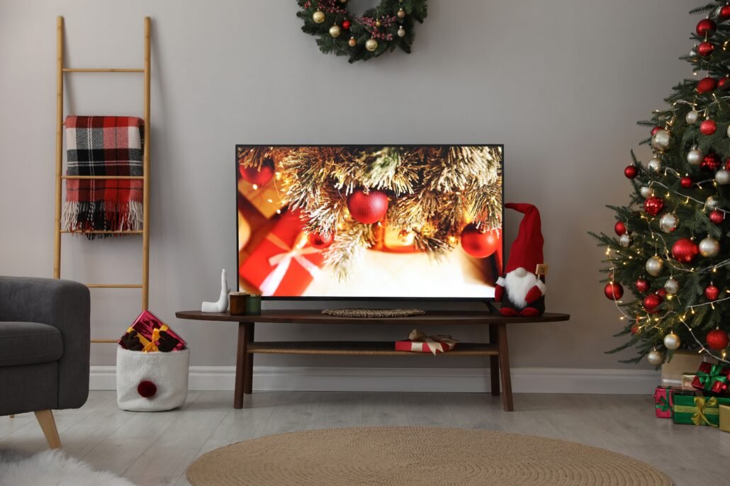 television-in-christmas-decorated-living-room-with-presents-and-baubles-on-screen