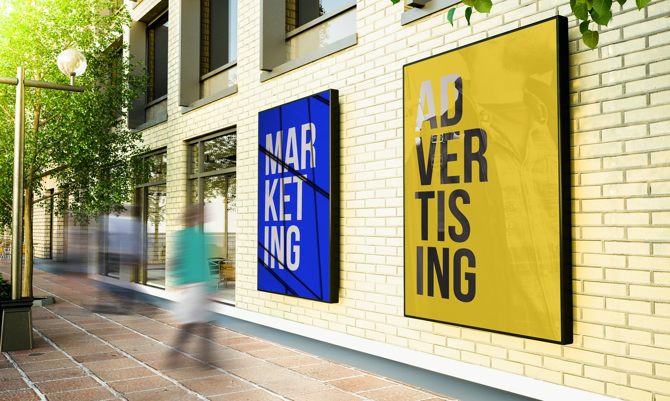 two-posters-on-a-city-building-one-says-marketing-and-the-other-says-advertising