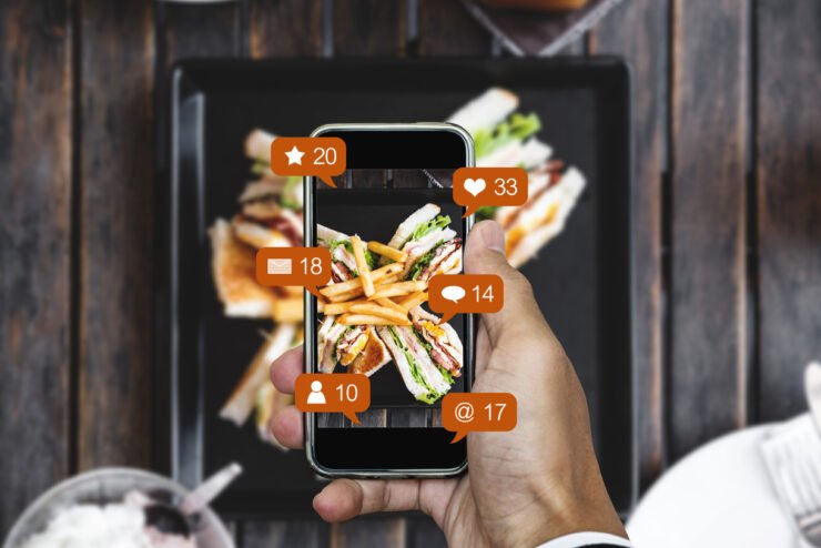 Taking-food-photograph-by-mobile-smart-phone-and-sharing-on-social-media-social-network-with-notification-icons