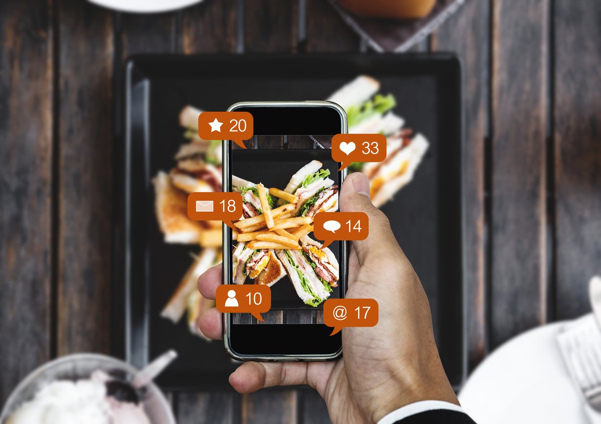 Taking-food-photograph-by-mobile-smart-phone-and-sharing-on-social-media-social-network-with-notification-icons