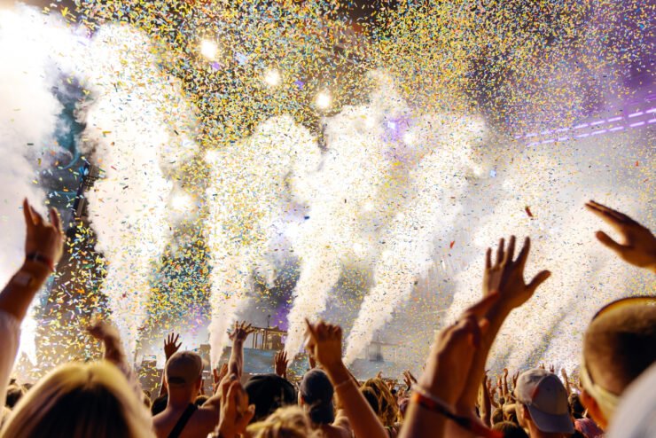 People-Cheering-and-Dancing-under-Confetti-at-Music-Festival-with-intense-Light-Show