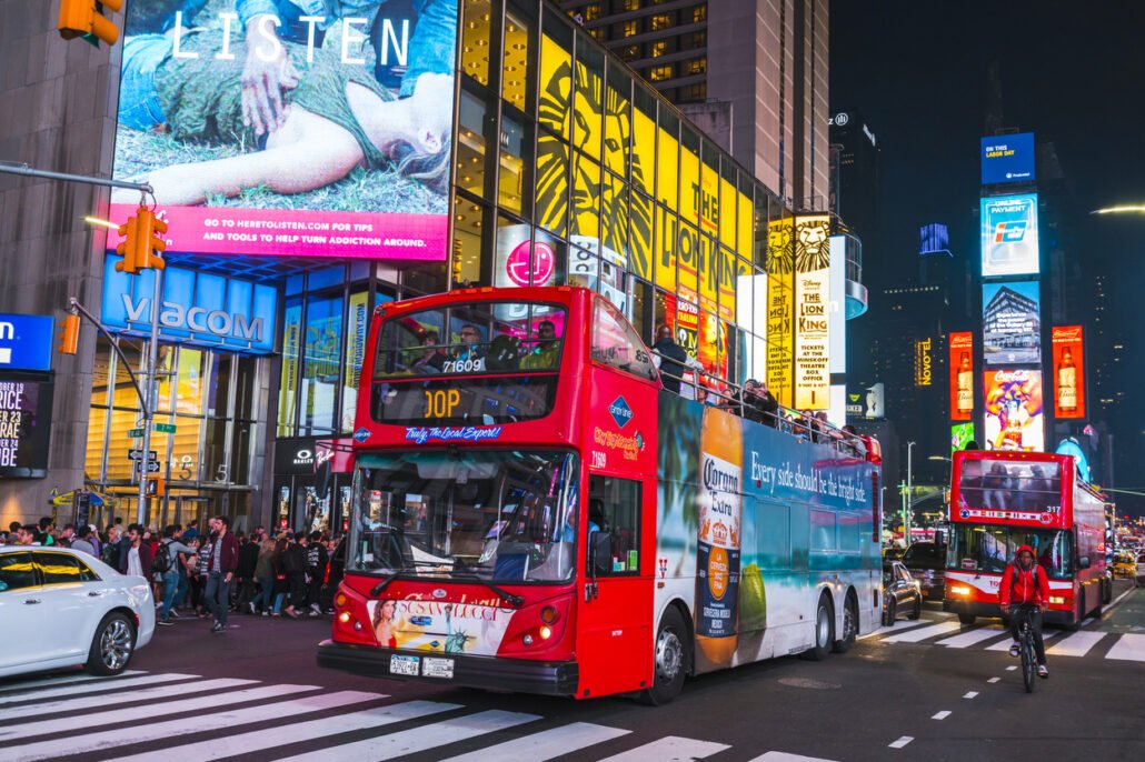 Time-square-at-night- with-crowds-and-traffic-consumer-marketing-billboards