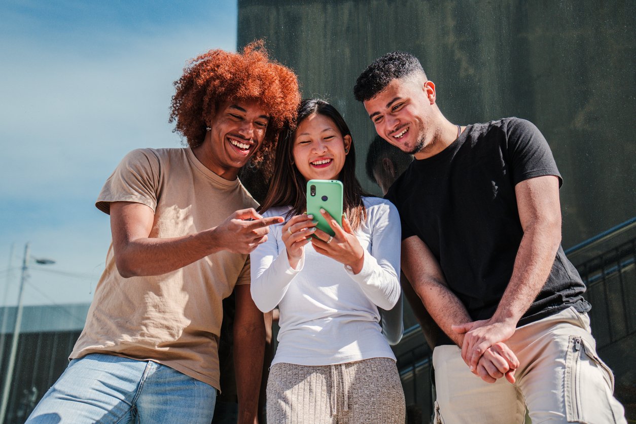 Young-adults-watching-viral-marketing-campaign-on-smart-phone