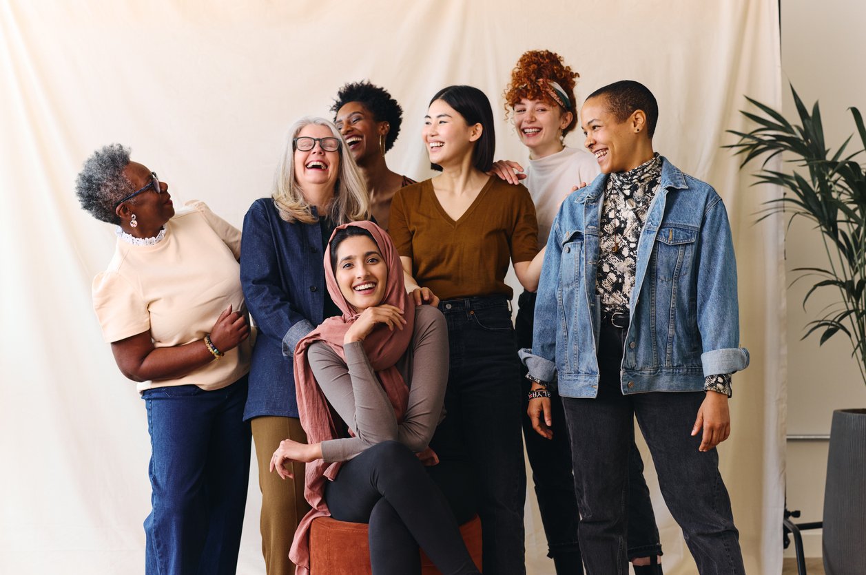 Portrait-of-cheerful-mixed-age-range-multi-ethnic-women-celebrating-International-Women's-Day