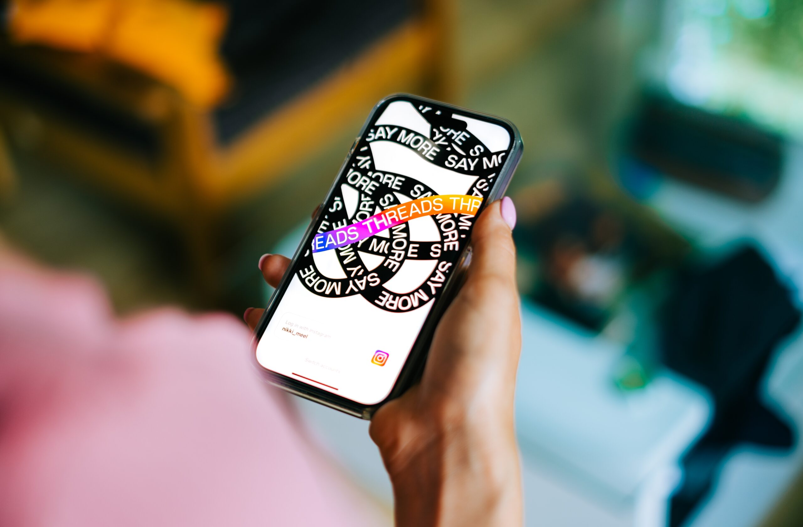 Hands-holding-iPhone-with-Meta-Threads-App-open