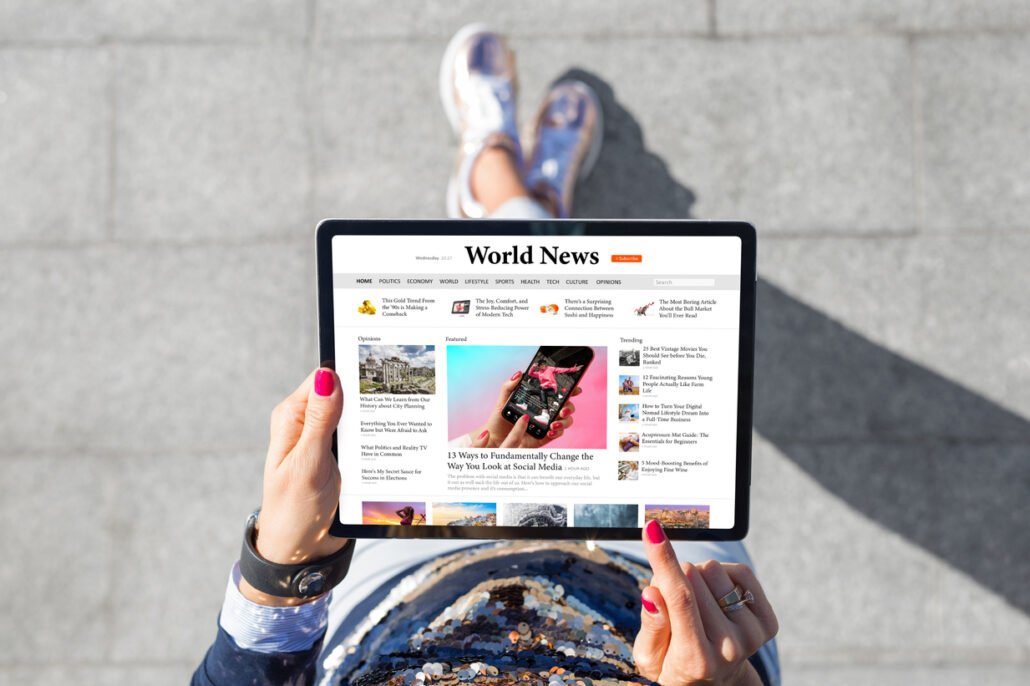 Woman-standing-outdoors-and-reading-social-media-news-on-tablet-computer