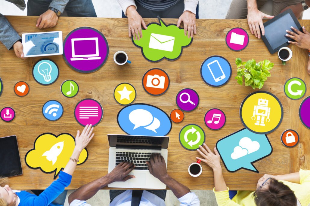 PR-and-marketing-professionals-connecting-earned-media-with-social-media-icons-on-a-table