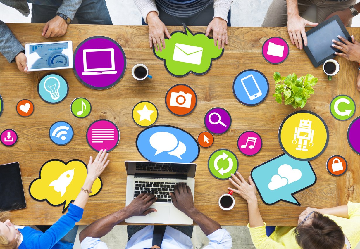 PR-and-marketing-professionals-connecting-earned-media-with-social-media-icons-on-a-table